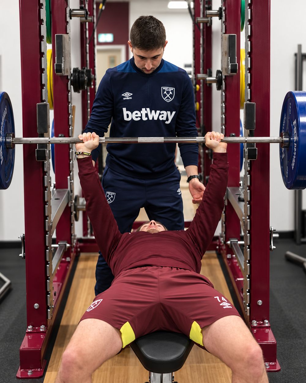Leon Foley coaching an athlete through a bench press